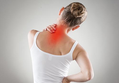 Woman holding neck due to chronic neck pain