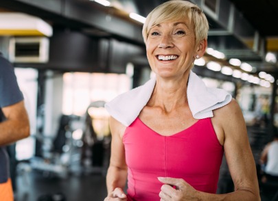 Smiling woman jogging on a treadmill