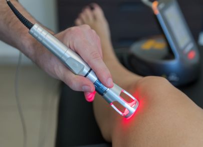Chiropractor performing soft tissue laser therapy
