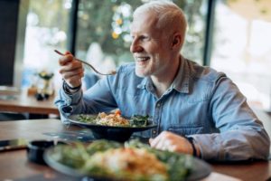 man eating healthy food and smiling