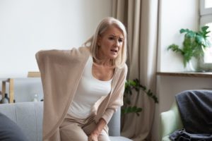 older woman experiencing sciatica-related back pain